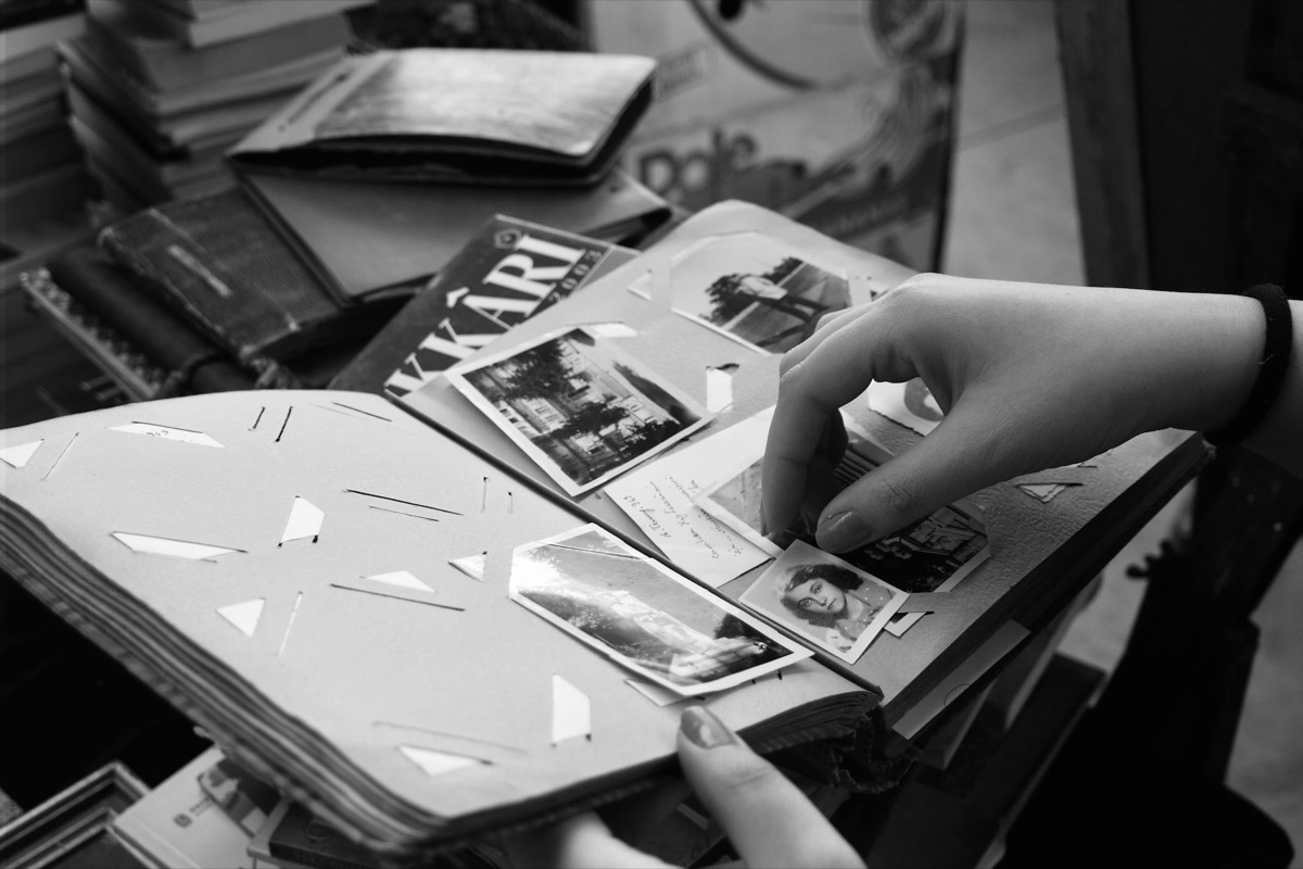 Hands turning the pages of an old family photograph album