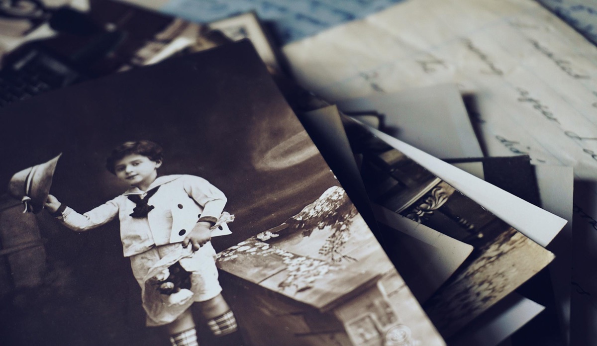 A close-up of vintage photographs and handwritten letters