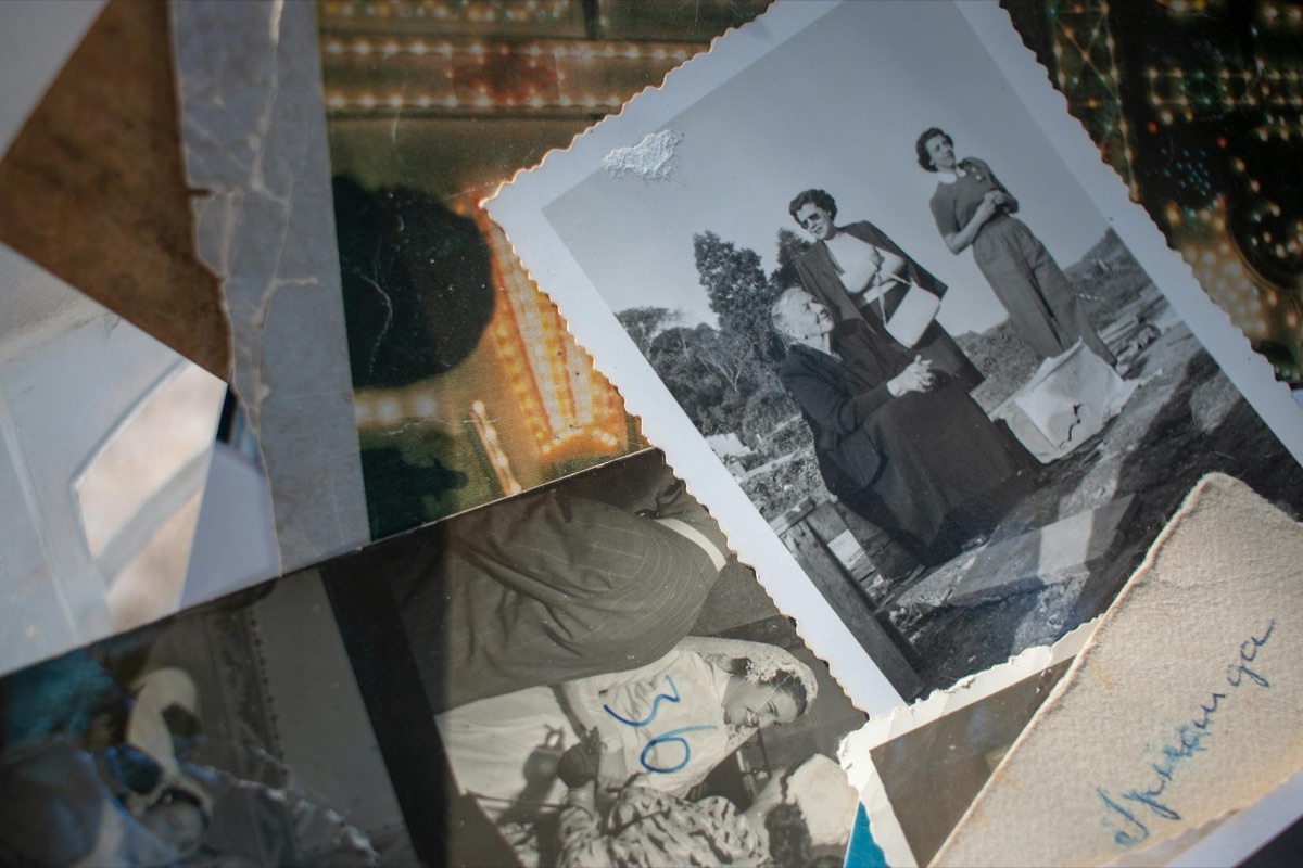 A collection of black-and-white family photographs spread on a table
