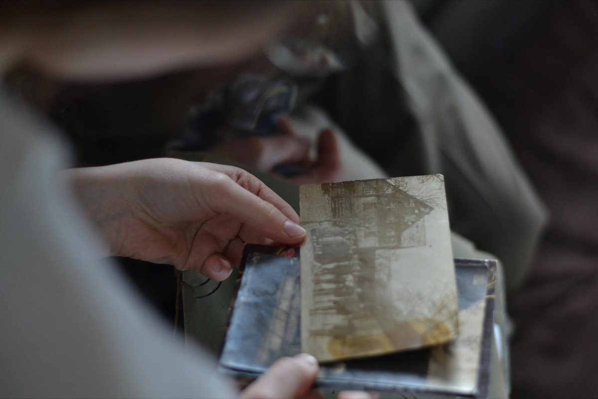 A hand holding an old family photograph
