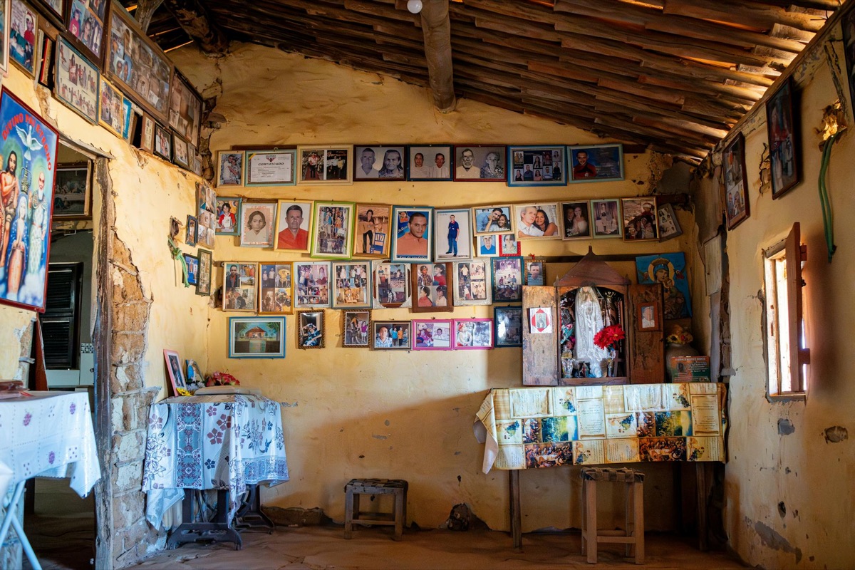 A warmly lit room filled with framed vintage family photographs